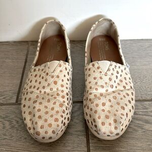 Tom’s slip on shoes. White with gold polka dots